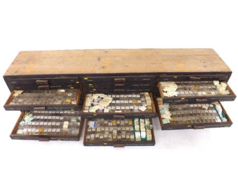 Twenty-one drawer wooden chest containing a very large quantity of watch stems (some with crowns) within named cases includin