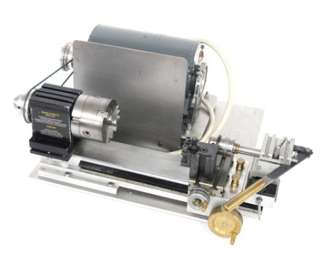 Peaton Precision lathe with electric motor, various attachments and an instruction manual, 18.75" wide overall