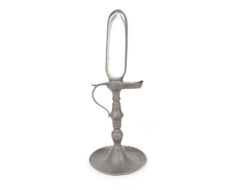 Antique pewter chamber stick candle clock, the glass reservoir over a thumb piece handle supported upon a turned knopped stem