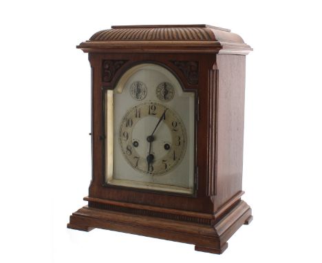 Junghans walnut three train bracket clock, the movement playing on four rods and striking the hours on a gong, the 6" silvere