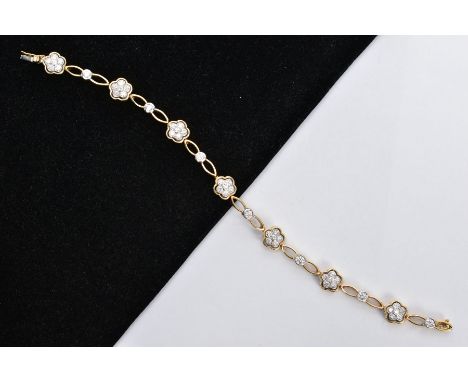 A MODERN 18CT GOLD DIAMOND FLOWER CLUSTER LINK PANEL BRACELET, comprising of seven round clusters set with brilliant cut diam