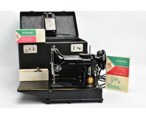 A CASED SINGER MODEL 222K PORTABLE SEWING MACHINE, serial number EJ622987, bears standard badge, comes with a Singer 'A Manua