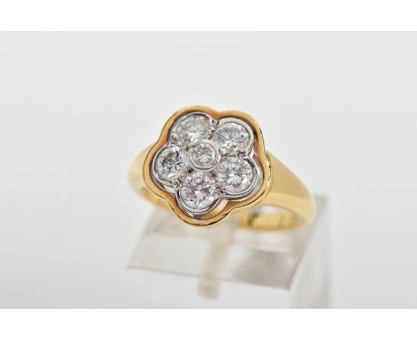 A MODERN DIAMOND CLUSTER RING, seven round brilliant cut diamonds, rim and grain set in a floral design to tapering shoulders