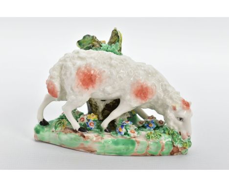 A DERBY PORCELAIN PATCH MARK FIGURE OF A GRAZING SHEEP BESIDE A STUMP, CIRCA 1770, naturalistically modelled and with floral 