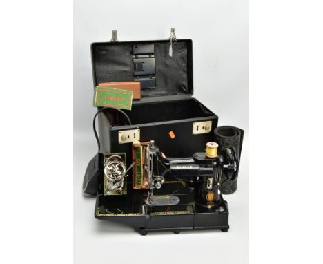 A CASED SINGER MODEL 222K FEATHERWEIGHT PORTABLE SEWING MACHINE, serial number EK324234, bears standard badge, comes with pow