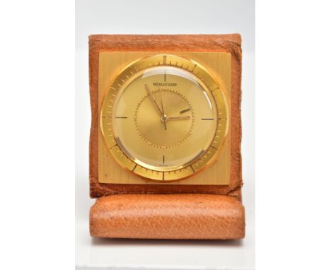 A GOLD PLATED JAEGER-LE COULTRE MEMOVOX TRAVEL ALARM CLOCK, a round champagne dial with quarter baton markers, alarm function