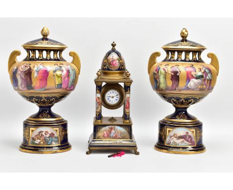 A LATE 19TH/EARLY 20TH CENTURY VIENNA PORCELAIN MATCHED CLOCK GARNITURE, the mantel clock of temple form with gilt metal moun