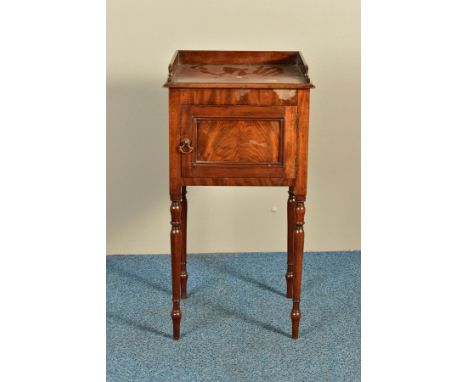 A REGENCY MAHOGANY POT CUPBOARD, the raised back and sides over a panelled single door, on turned legs, width 41cm x depth 35