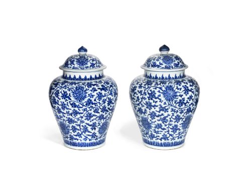 A PAIR OF BLUE AND WHITE BALUSTER JARS AND COVERSKangxiEach painted with a scrolling lotus design between a band of lotus bul