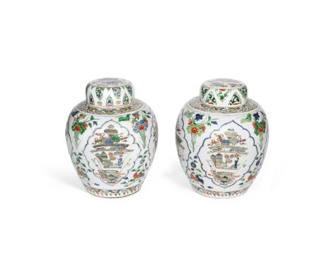 AN ASSOCIATED PAIR OF FAMILLE VERTE 'GINGER' JARS AND COVERSKangxiEach of ovoid form rising from a recessed base to a short t