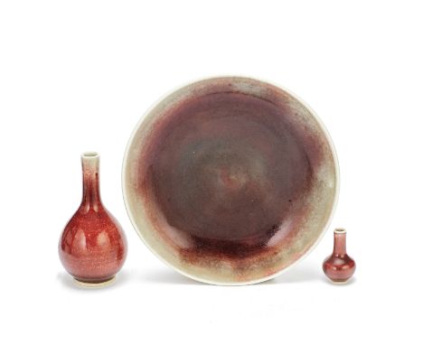 A GROUP OF THREE COPPER-RED-GLAZED WARESKangxi to 19th centuryComprising: a langyao pear-shaped bottle, the base covered in a