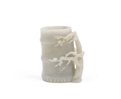 A PALE GREEN JADE BAMBOO-FORM VASEQing DynastyThe vessel in the form of a bamboo section, with a blossoming prunus tree to on