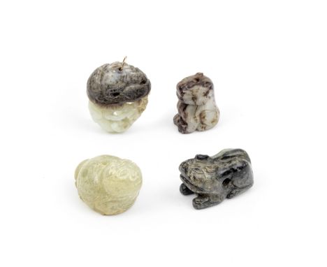 A GROUP OF FOUR JADE PENDANTSThe reticulated pendant, 18th/19th centuryComprising: a white and russet jade reticulated pendan