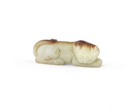 A PALE GREEN AND RUSSET JADE FIGURE OF A CATQing DynastyThe recumbent feline with the head turned to the right and the tail c