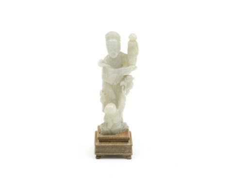 A PALE GREEN JADE FIGURAL CARVING18th/19th centuryModelled as an elegant lady holding aloft a wrapped vessel to one side, a g