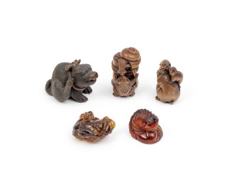 FOUR NESTUKE AND ONE CHINESE AMBER PENDANTComprising: a wooden netsuke group with two rabbits; a wooden netsuke carving with 