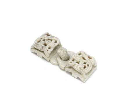A CHICKEN BONE JADE BELT-BUCKLE16th/17th centuryOf cream and mushroom hue, the sides carved in openwork with coiled chilong a