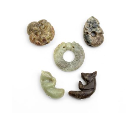 A GROUP OF FIVE ARCHAISTIC JADE CARVINGSComprising: a Garuda; a pig-dragon; a carved disc of two stylised dragons clasping a 