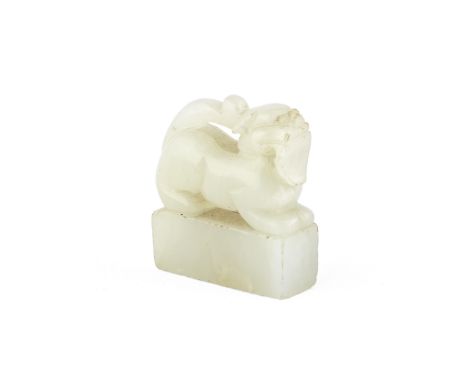 AN INSCRIBED JADE SEAL18th/19th centuryModelled as a lion-dog on all fours upon a rectangular plinth, inscribed to the seal f