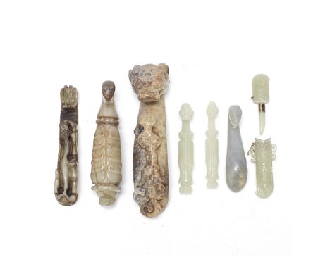 A GROUP OF SIX JADE BELT HOOKS AND A MINIATURE JADE DAGGERQing Dynasty and laterComprising: two yellow and russet jade 'chilo