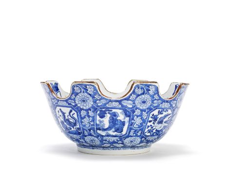 A RARE BLUE AND WHITE MONTEITHKangxi, c. 1700-1715The crenelated rim dressed in a café-au-lait glaze, the exterior decorated 