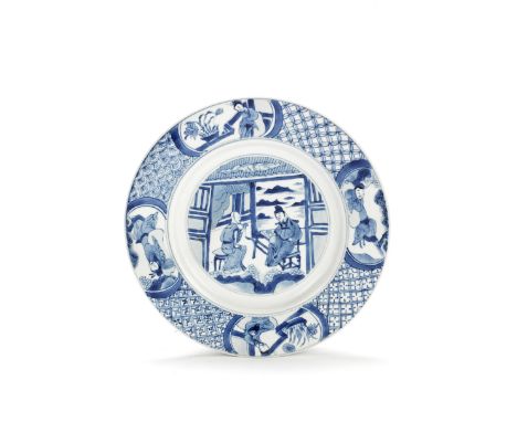 A BLUE AND WHITE FIGURAL DISHKangxi six-character mark and of the periodThe centre painted with a scholar talking with a eunu