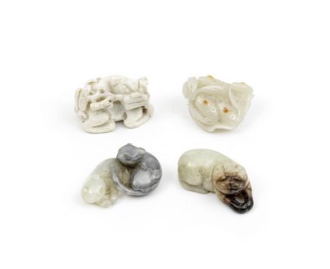 FOUR JADE ANIMAL CARVINGSThe two carvings of felines, Qing DynastyComprising: a creamy white jade Buddhist lion grasping a br