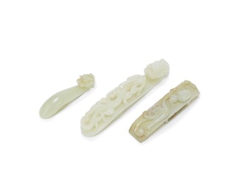 A GROUP OF THREE PALE GREEN JADE 'DRAGON' BELT HOOKS18th/19th centuryComprising: one with a dragon-head hook and a circular s