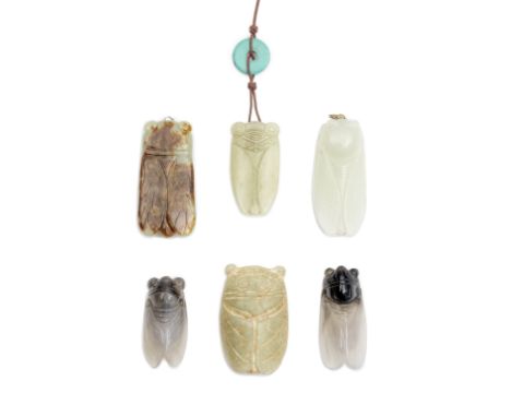 A GROUP OF FOUR JADE AND TWO AGATE 'CICADA' PENDANTSComprising: two yellow jade cicadas, one mainly calcified; a pale green a