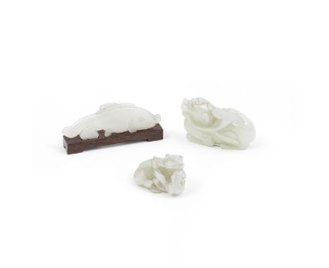 THREE PALE GREEN AND WHITE JADE ANIMALS18th/19th centuryComprising: a pale green jade recumbent figure of a bixie grasping a 