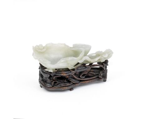 A JADE 'LOTUS' BRUSH WASHER AND WOOD STAND19th centuryOf mainly even pale green hue and formed as ribbon-tied stems of lotus 