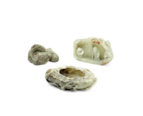A GROUP OF THREE JADESQing Dynasty and laterComprising: a mottled grey and white jade 'lotus' brush washer; a green and brown