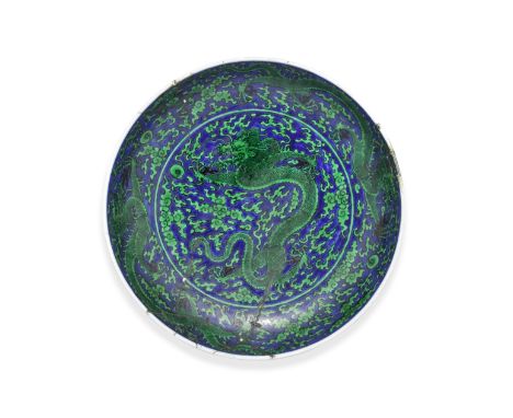 A FINE BLUE-GROUND GREEN-ENAMELLED 'DRAGON' DISHKangxi six-character mark and of the periodThe rounded sides rising from a ta