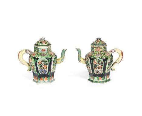 A PAIR OF BLACK-GROUND FAMILLE VERTE BISCUIT RETICULATED EWERS AND COVERSKangxiThe hexagonal vessels decorated to each side w