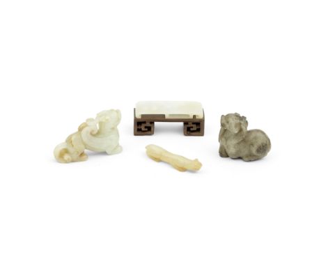 A GROUP OF FOUR JADE CARVINGS18th centuryComprising: a white jade figure of a bixie with the mouth open in a fierce expressio