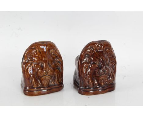 Pair of 19th Century treacle glazed sash window rests, with lion mask decoration, 13cm high