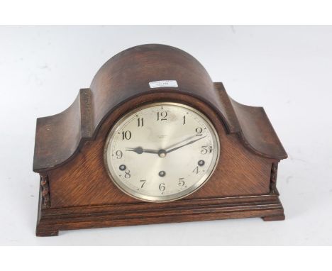 J. A. Haskell of Ipswich oak cases mantle clock with a silvered dial and Arabic numerals with a three train movement with fiv