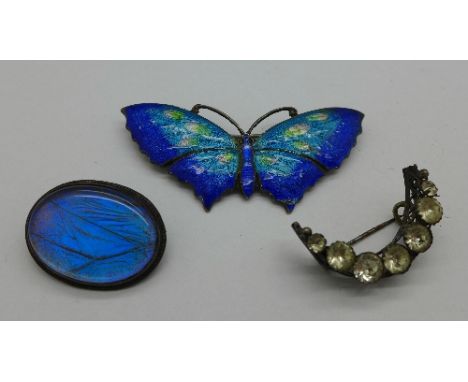 A silver and enamel butterfly brooch, a butterfly wing brooch and a past crescent brooch