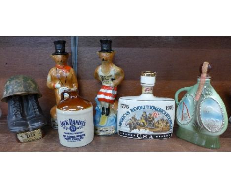 Four Jim Beam 100 month old whisky decanters, seals intact comprising two fox decanters (The Surfer and one other), a G.I. he