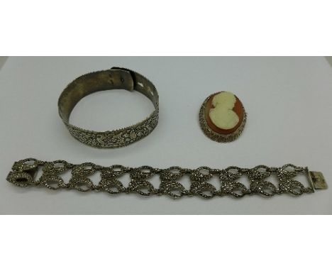 An .800 silver cameo brooch, a silver and marcasite bracelet and a silver bangle, Chester 1944 by Charles Horner, 66g