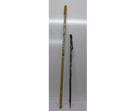 A scout's staff with enamel badges and a walking stick with enamel badges