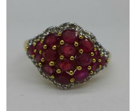 A ruby and white topaz ring, T