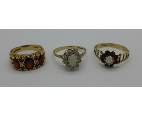 Three 9ct gold rings, opal, 1.7g, K, red stone, 3.8g, L and red and white stone 1.9g, R