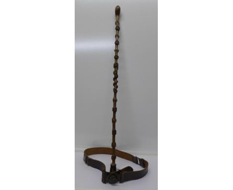 A knobbly walking stick and a boy scout's leather belt