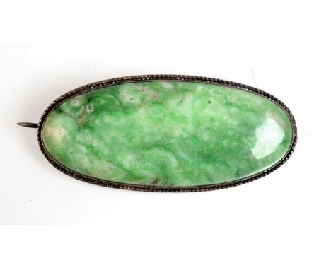 A large oval jade silver mounted brooch.