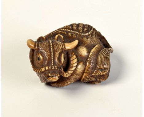 A Japanese ivory large netsuke, in the form of a recumbent buffalo. Condition Report: Good condition, maximum length 6.7cm, m