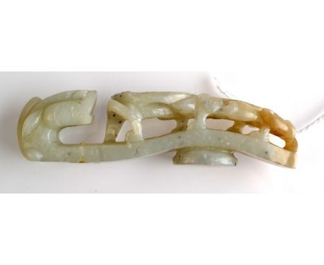 THE LESLIE DAVIE COLLECTION OF JADE

A pale green jade belt hook of traditional dragon shape with dark flecks and a hint of r