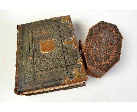 A Victorian leather bound family Bible with brass catches dated 1856 together with a leather clad octagonal box embossed with