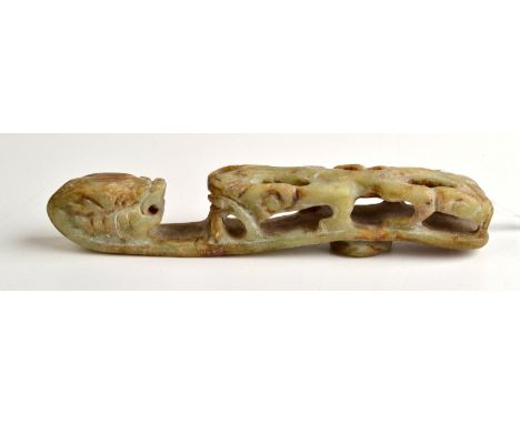 THE LESLIE DAVIE COLLECTION OF JADE

A mottled green and brown jade belt hook in archaic style, 13cm.