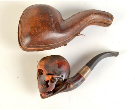 A meerschaum skull and crossbones pipe in fitted case. Condition Report: Signs of use, no cracks